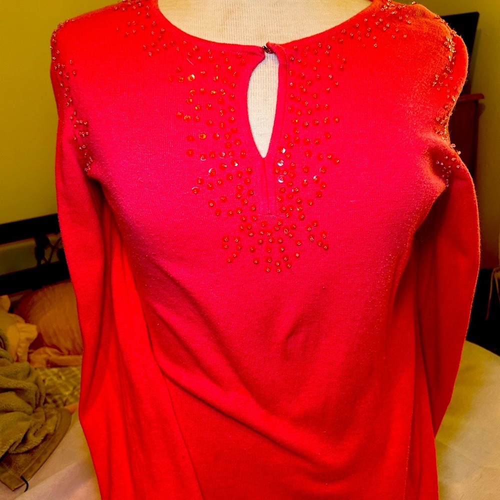A sweater of coral and beading. No beading missing that I’ve found. Not tight.